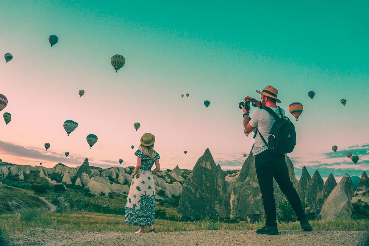 Quisque faucibus laoreet eros vel Man taking photo of hot air balloons
