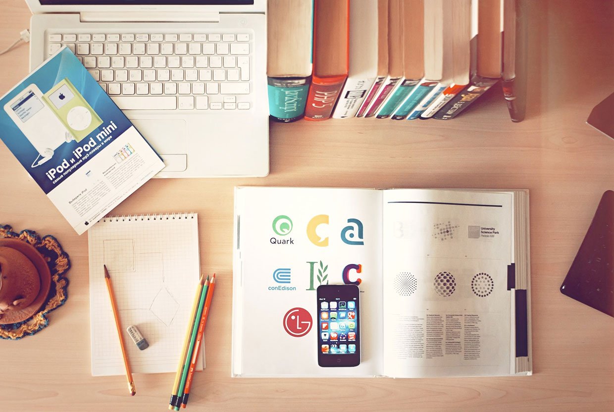 Sed sodales erat ac velit Pencils and phone on top of books