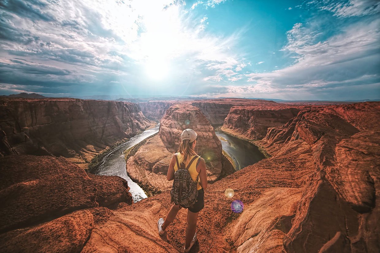 Curabitur lorem magna scelerisque a purus nec Woman standing on top of canyon